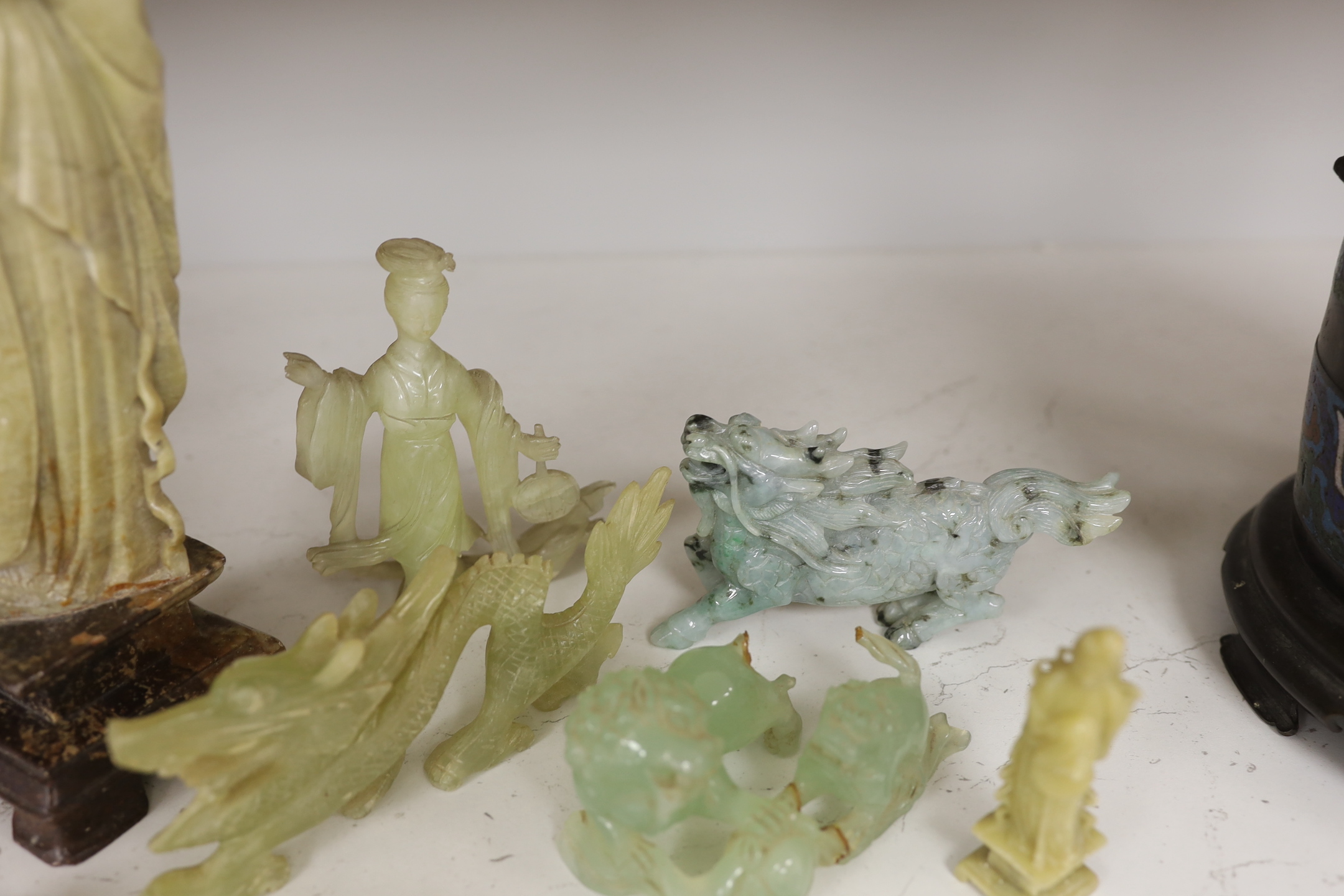 A Chinese soapstone figure, a jadeite figure of a qilin and various bowenite figures etc., tallest 30cm